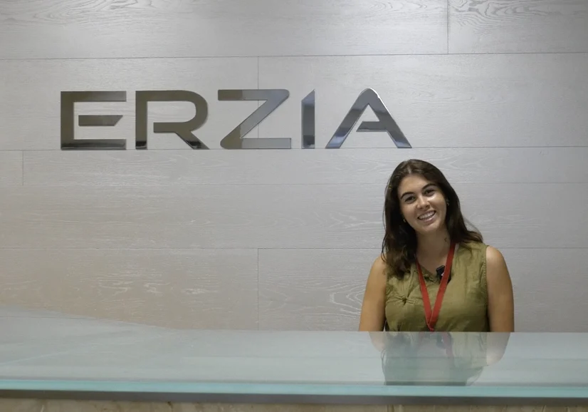 Staff member at ERZIA standing behind a desk